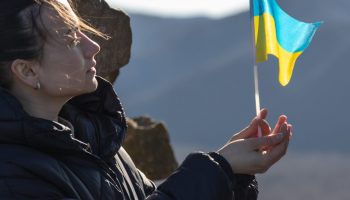 young-woman-with-the-flag-of-ukraine-in-her-hands-1920x650